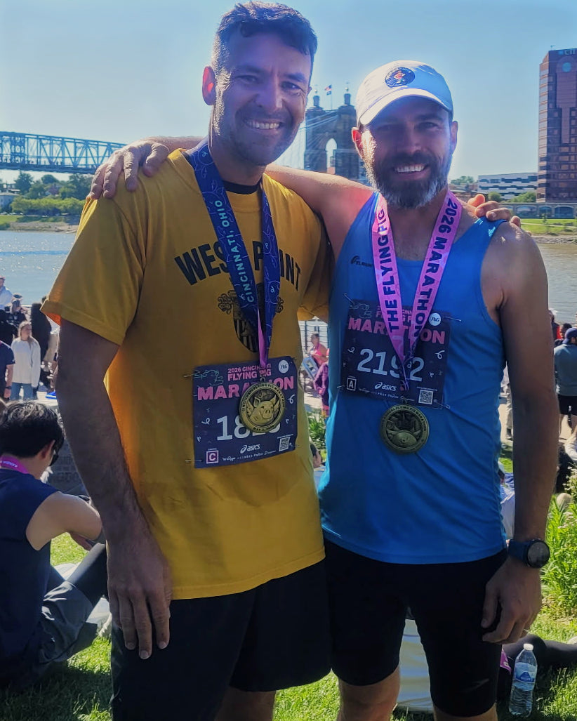 Two runners finishing the Flying Pig Marathon together, Cincinnati Ohio with Peregrune Runner Vitamins and Supplements