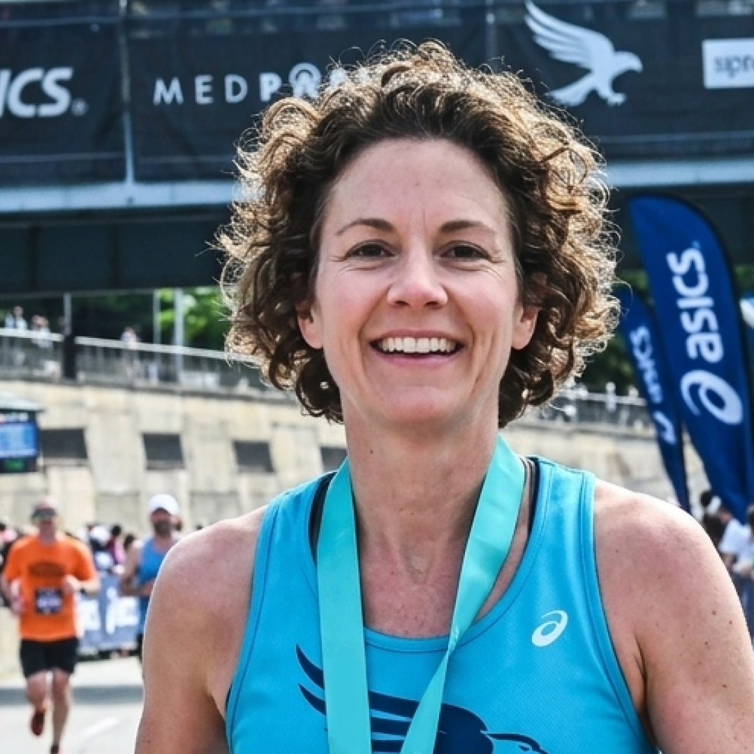 Runner at finish line using Peregrune Runner Vitamins and Runner Supplements