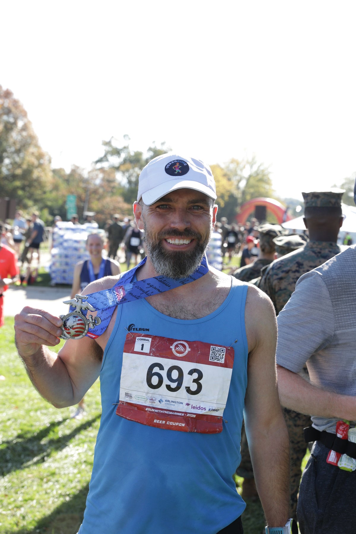 George Parker holding his Marine Corps Marathon finisher medal